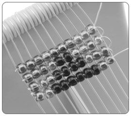 Four rows of beads on a loom